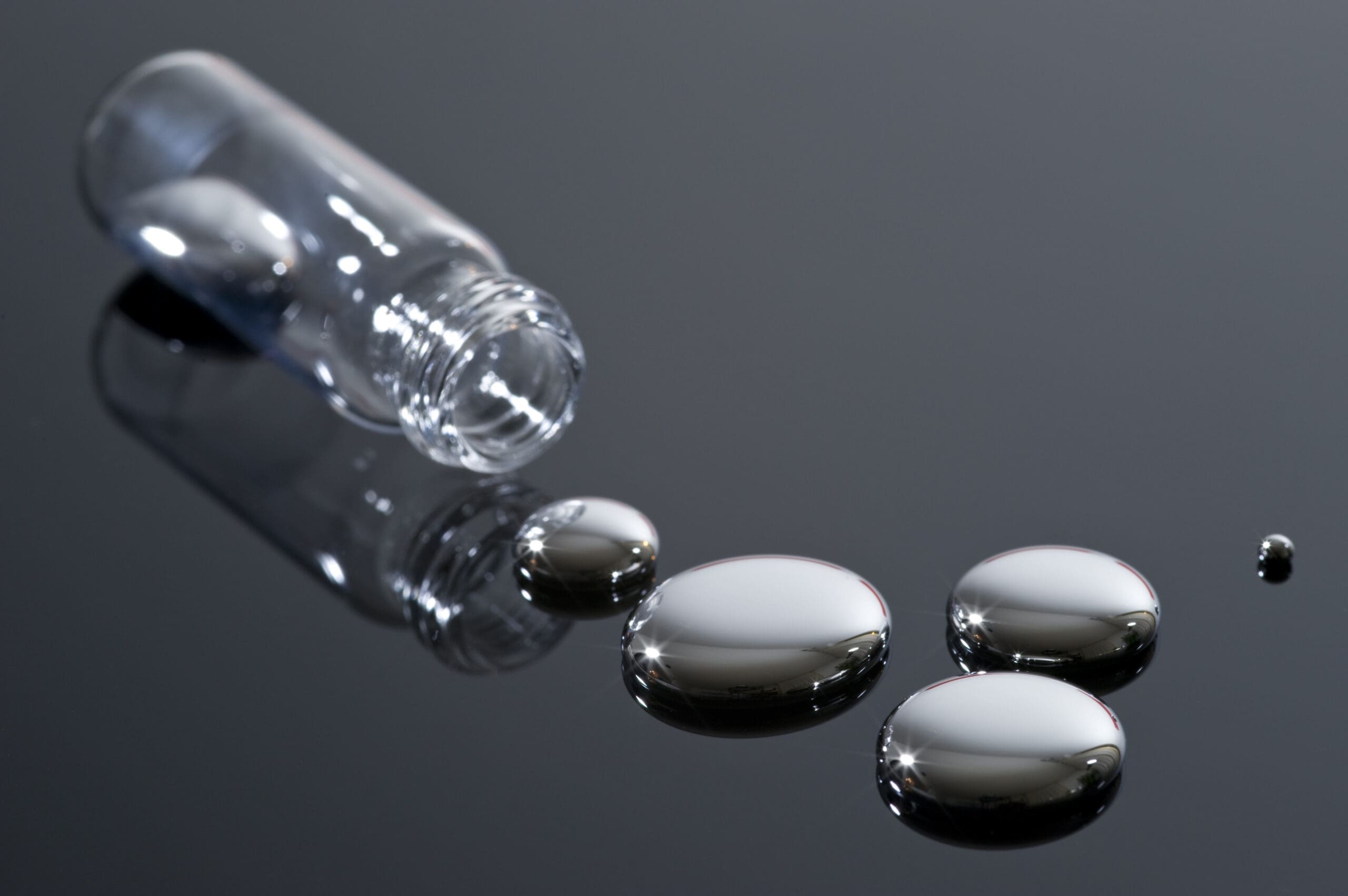 Mercury,And,Glass,Container,On,A,Reflective,Surface